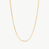 14K solid yellow gold snake chain necklace featuring a sleek, herringbone design. This minimalist and elegant chain offers a smooth, fluid texture, perfect for layering or wearing as a statement piece for everyday sophistication.