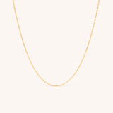14K solid yellow gold dainty curb chain necklace with a minimalist design, featuring delicate Cuban links. Perfect for layering or wearing solo, this timeless gold chain adds elegance to any look, ideal for daily wear or special occasions.