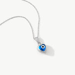 Blue heart evil eye necklace in 14K yellow gold. A dainty protective charm necklace with a modern design, ideal for adding a touch of luck and style to any outfit.