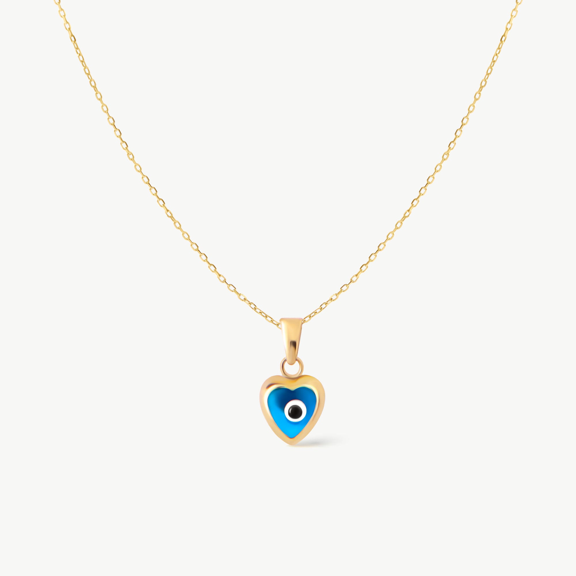 Blue heart evil eye necklace in 14K yellow gold. A dainty protective charm necklace with a modern design, ideal for adding a touch of luck and style to any outfit.