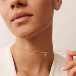 Blue heart evil eye necklace in 14K yellow gold. A dainty protective charm necklace with a modern design, ideal for adding a touch of luck and style to any outfit.