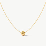 14K real solid yellow gold minimalist necklace featuring a single floating gold bead. A dainty and elegant everyday accessory perfect for layering or wearing alone.