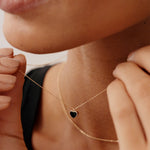 Delicate 14K solid gold necklace with a black enamel heart charm. Ideal for layering or as a statement piece, this minimalist pendant offers a timeless and romantic look for daily wear.