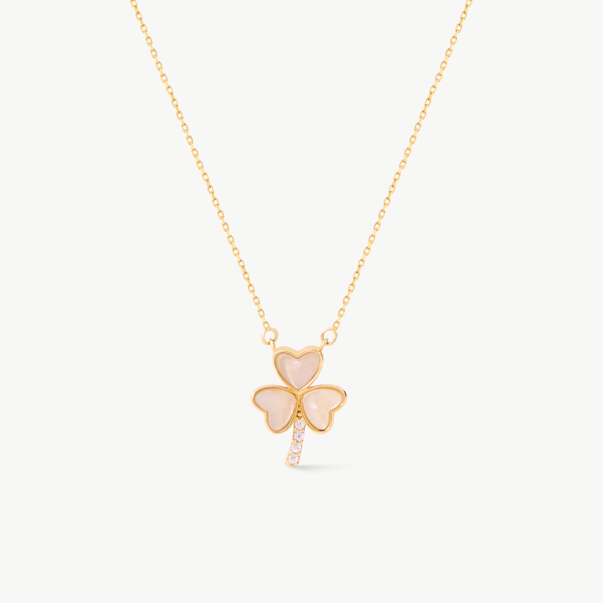 14K solid yellow gold shamrock pendant necklace featuring heart-shaped mother of pearl leaves and a diamond-accented stem. This elegant Saint Patrick’s clover symbolizes good luck and charm, perfect for everyday wear or as a special gift.