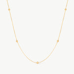 14K solid yellow gold beaded satellite chain necklace featuring small, evenly spaced textured beads. This minimalist and dainty necklace offers a delicate design, perfect for layering or as an elegant everyday accessory.
