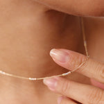 Real 14K yellow gold satellite chain necklace with tiny tricolor beads, including rose, white, and yellow gold accents. The minimalist design adds a subtle elegance, making it ideal for layering with other pieces or wearing solo as a delicate statement.