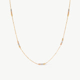 14K solid gold tricolor beaded station necklace featuring delicate yellow, rose, and white gold beads along a minimalist chain. This dainty and elegant piece is perfect for layering or wearing alone, offering a versatile and sophisticated look for any occasion.