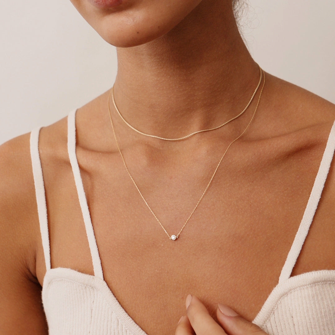 14K Real Solid Gold necklace with an F color solitaire diamond in a bezel setting, showcasing minimalist elegance and perfect for gifting or daily wear. Ideal for those who value understated luxury.