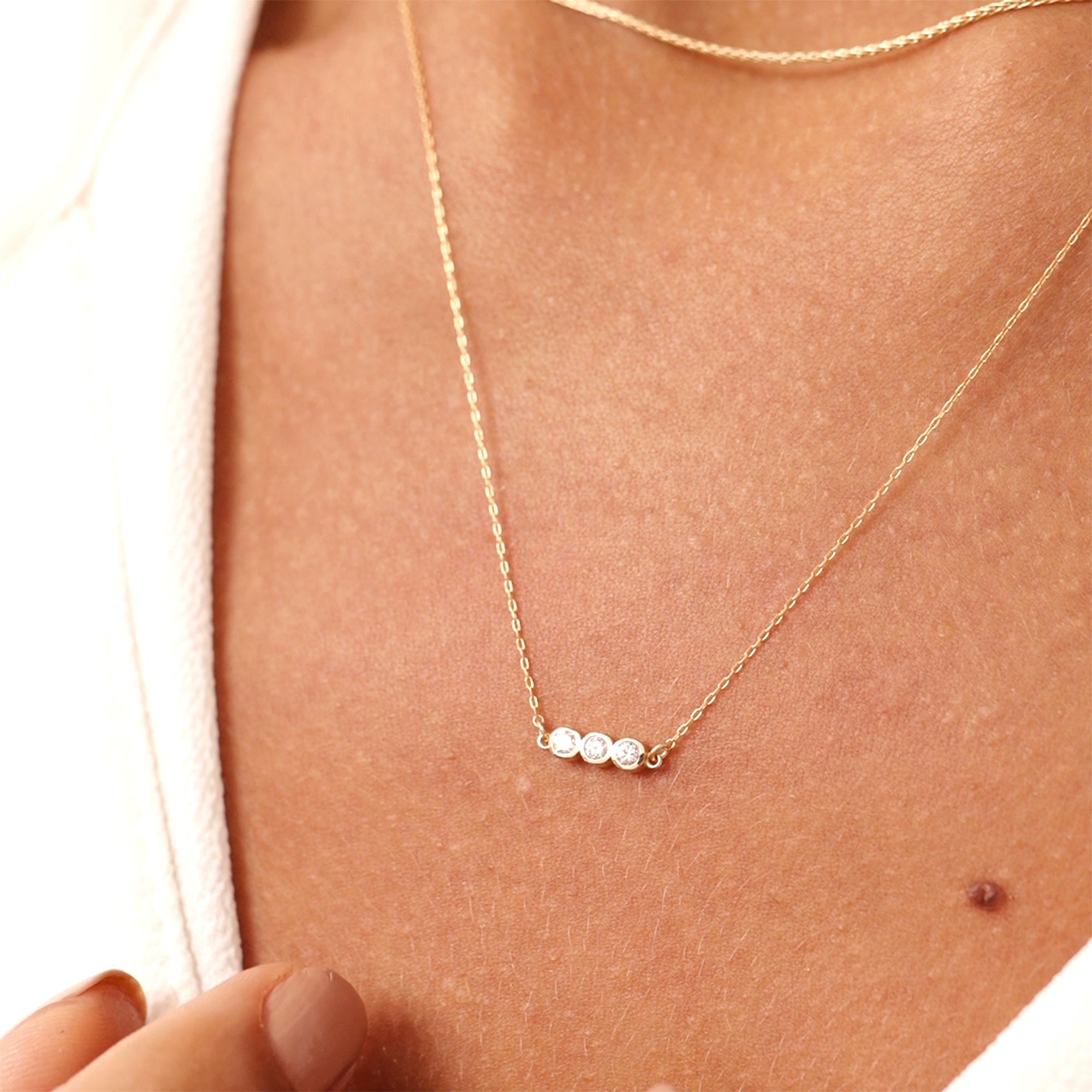 14K gold diamond bezel necklace with three bezel-set diamonds in a sleek linear design, perfect for anniversaries, birthdays, or everyday wear, adding elegance and sparkle to any outfit.