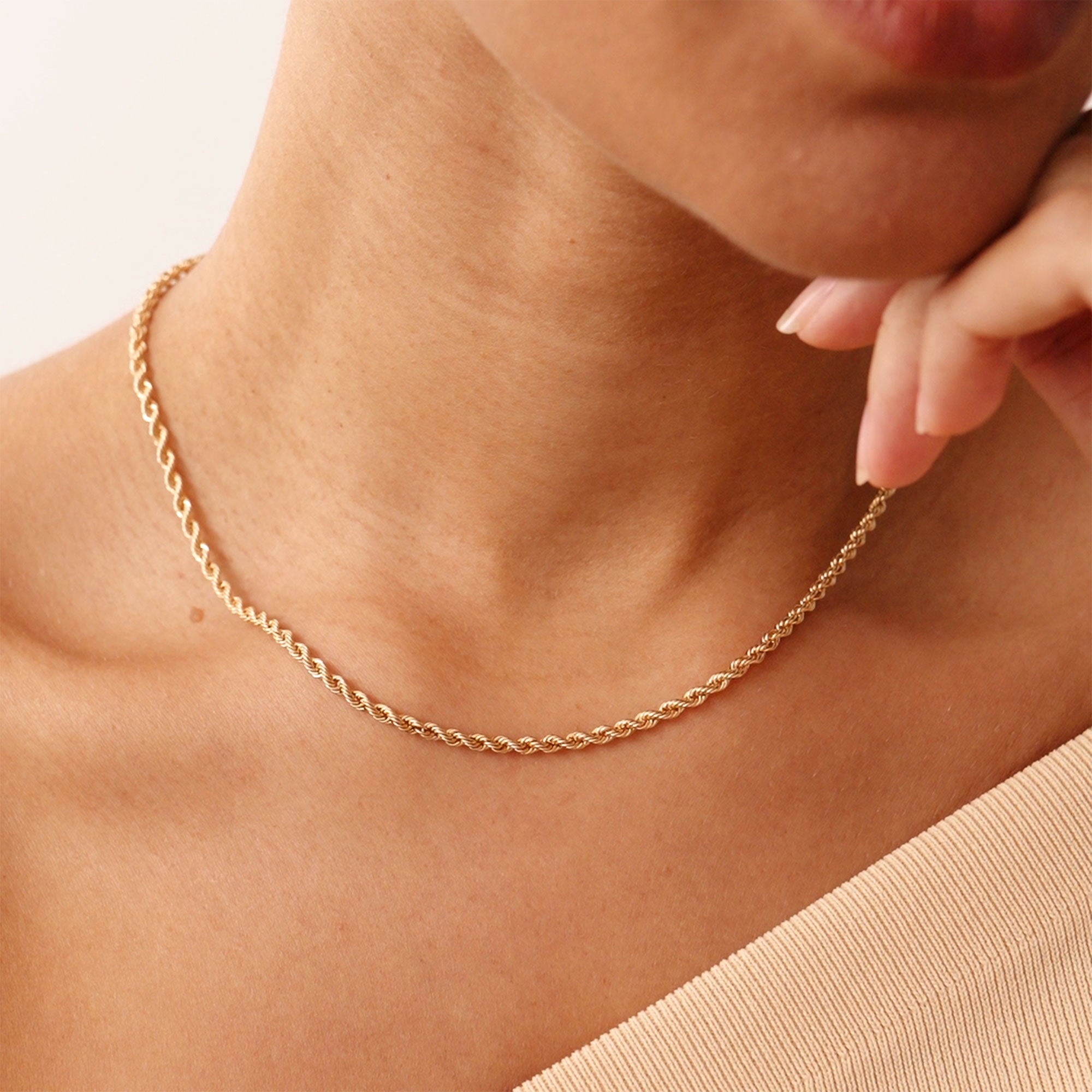 A 14K real solid gold thick rope chain necklace with a twisted design, featuring a lobster clasp closure, suitable for men and women, available in 14, 16, 18, and 20 inches, perfect for layering or as a standalone accessory.