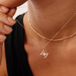 14K gold evil eye necklace with an opal centerpiece set in a geometric pendant, featuring an adjustable chain with 14, 16, 18, and 20-inch length options. Stylish and symbolic, perfect for protection and gifting.