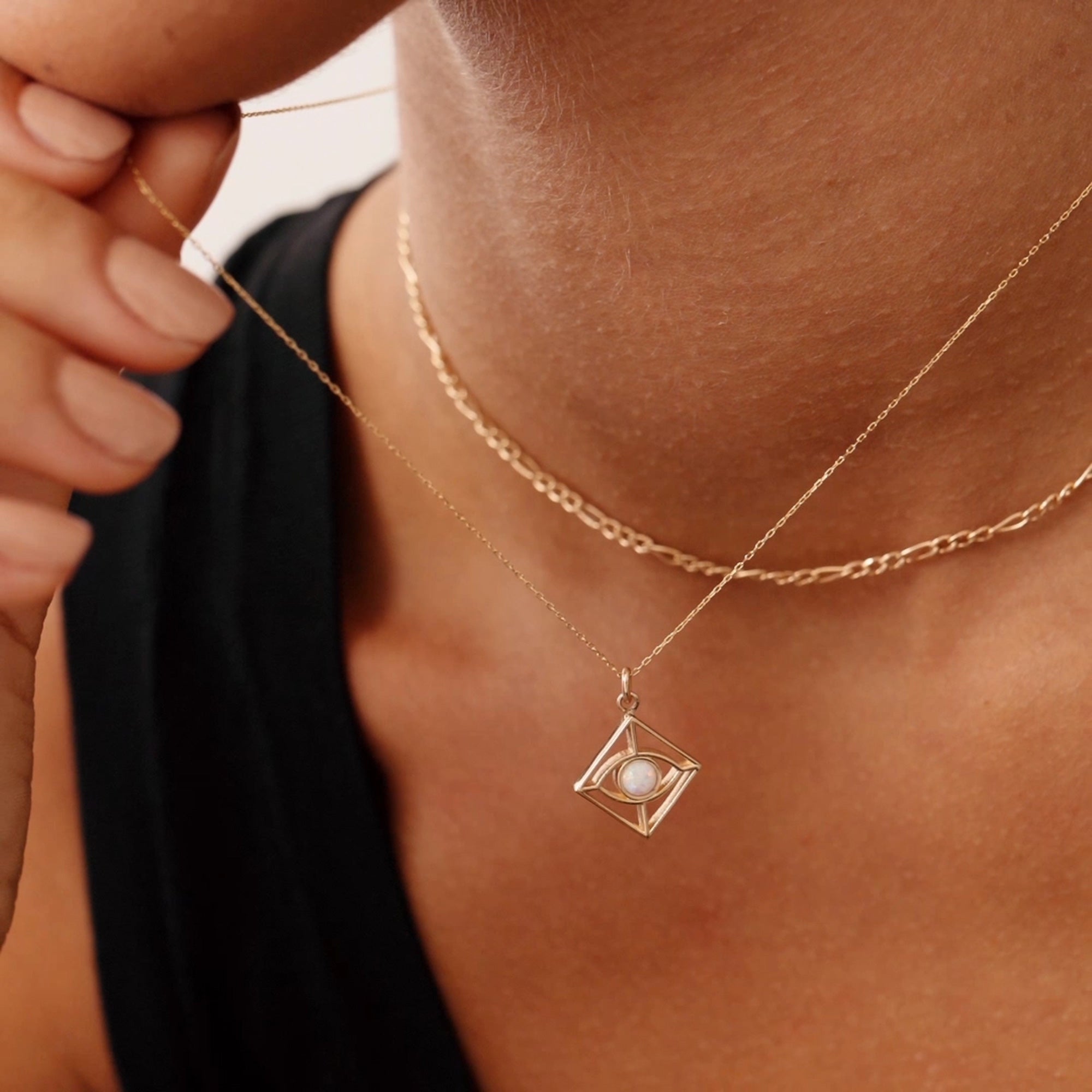 14K gold evil eye necklace with an opal centerpiece set in a geometric pendant, featuring an adjustable chain with 14, 16, 18, and 20-inch length options. Stylish and symbolic, perfect for protection and gifting.