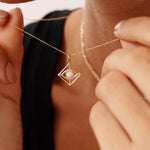 14K gold evil eye necklace with an opal centerpiece set in a geometric pendant, featuring an adjustable chain with 14, 16, 18, and 20-inch length options. Stylish and symbolic, perfect for protection and gifting.