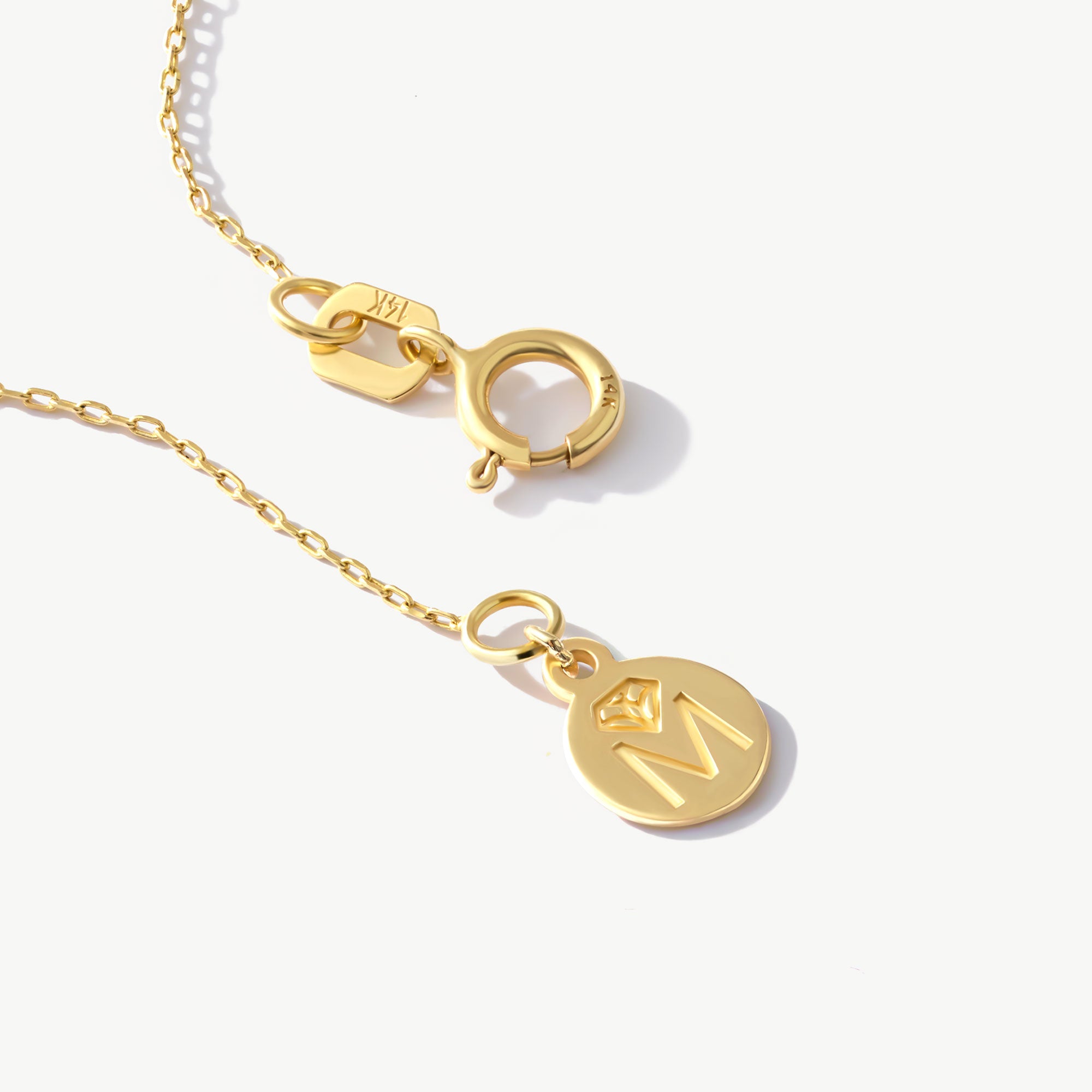Secure 14K gold cable chain with spring ring clasp and 14K authenticity stamp.