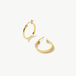 14K real solid yellow gold huggie hoop earrings featuring a sleek and minimalist design. These small, medium-sized hoops offer a polished and refined look, perfect for everyday wear or layering with other jewelry.