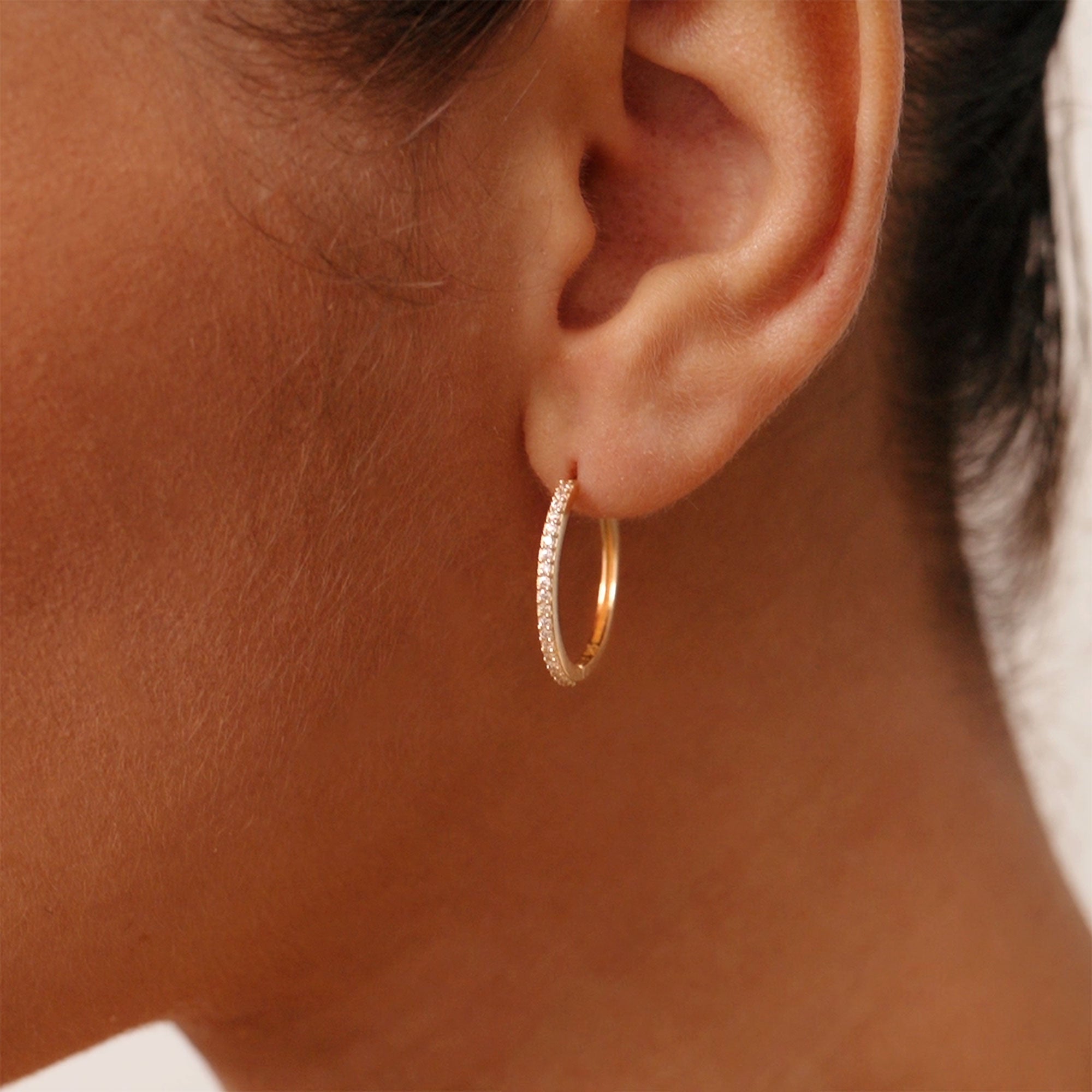 14K real solid gold huggie hoop earrings with cubic zirconia stones, standard size with secure hinged clasp, perfect for stacking or wearing alone, a beautiful accessory for daily wear or as a gift for special occasions.