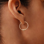 14K gold beaded hoop earrings with lever-back clasp, featuring delicate gold beads for added charm and elegance, perfect for both everyday wear and special occasions.