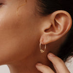 14K gold beaded hoop earrings with lever-back clasp, featuring delicate gold beads for added charm and elegance, perfect for both everyday wear and special occasions.
