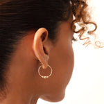 14K gold beaded hoop earrings with lever-back clasp, featuring delicate gold beads for added charm and elegance, perfect for both everyday wear and special occasions.