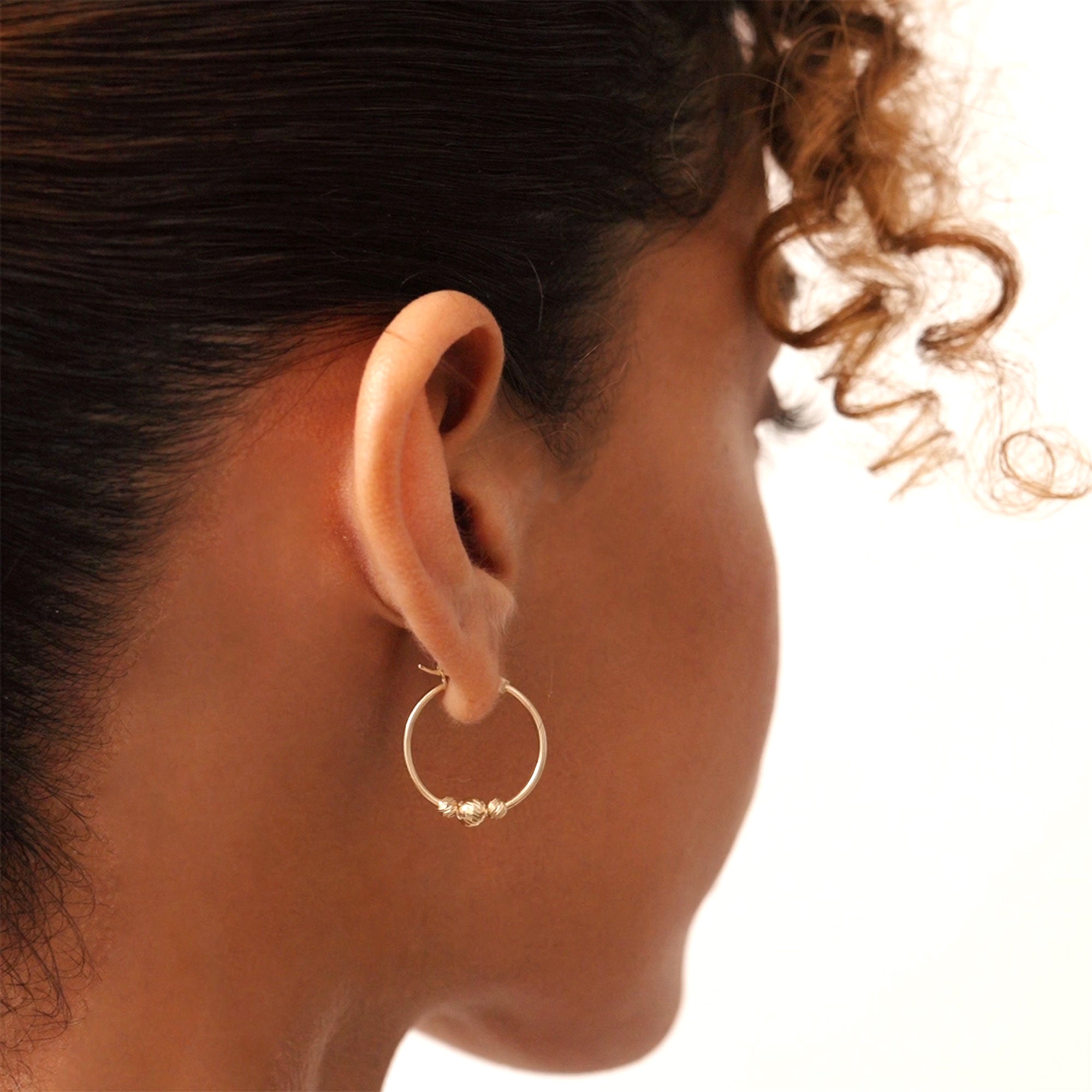 14K gold beaded hoop earrings with lever-back clasp, featuring delicate gold beads for added charm and elegance, perfect for both everyday wear and special occasions.