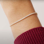 14K Real Solid Gold Cubic Zirconia Tennis Bracelet with a continuous line of cubic zirconia stones, perfect for adding sparkle to any outfit; ideal as a gift for birthdays, anniversaries, or special occasions.