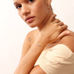 Dainty 14K gold evil eye bracelet with an adjustable chain and lobster clasp, featuring a delicate charm symbolizing protection and good fortune. Perfect for gifting as a Christmas present, birthday gift, or friendship bracelet. Ideal for everyday wear and layering.