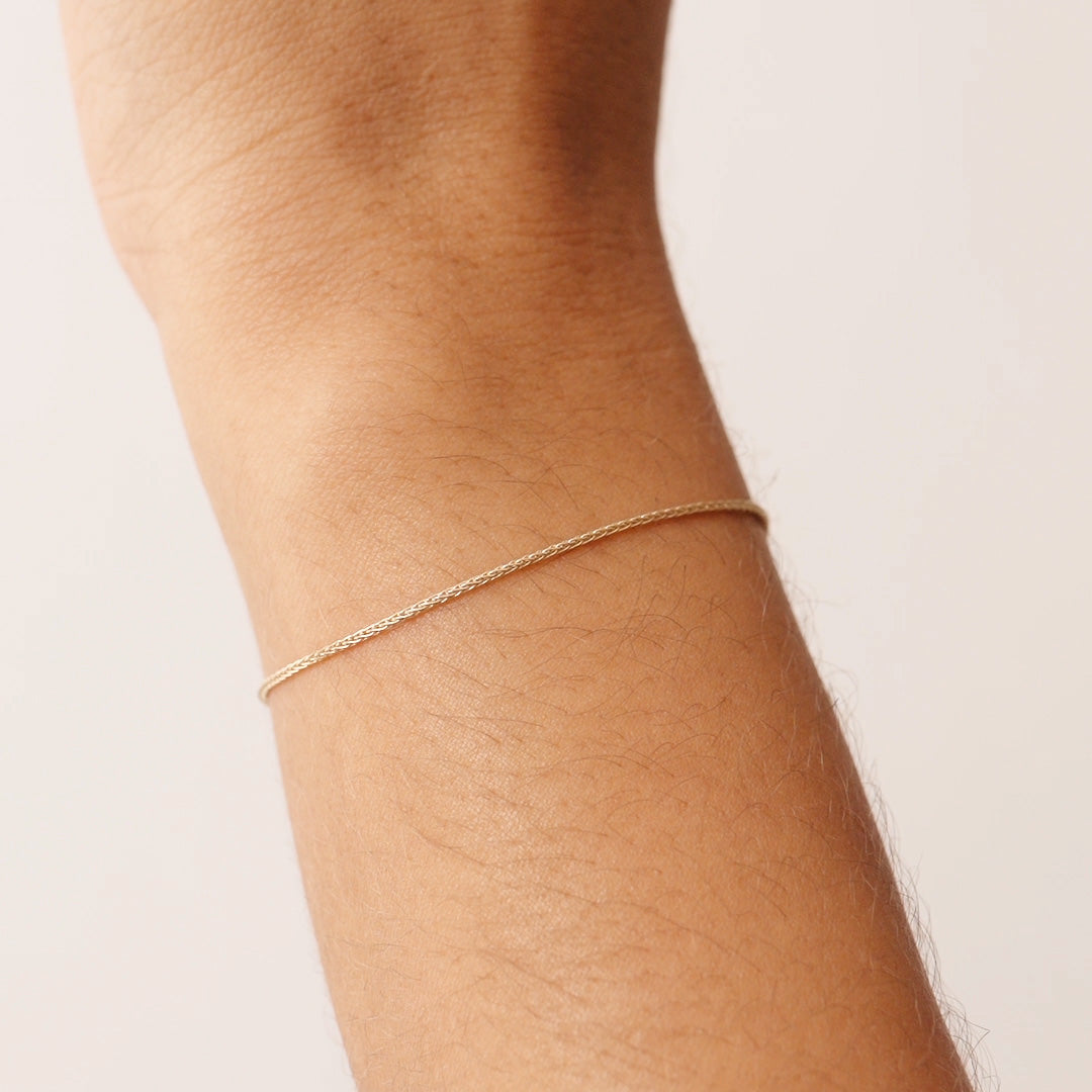 14K Real Solid Gold Wheat Chain Bracelet with an adjustable length and secure spring ring clasp, featuring an elegant and durable wheat chain link design.