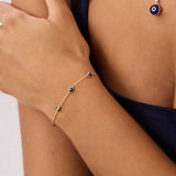 A 14K Real Solid Gold London Blue Topaz Birthstone Station Bracelet featuring deep blue, faceted gemstones set along a fine gold chain, perfect for elegant wear.