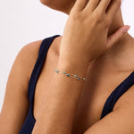 A 14K Real Solid Gold London Blue Topaz Birthstone Station Bracelet featuring deep blue, faceted gemstones set along a fine gold chain, perfect for elegant wear.