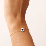 14K Real Solid Gold Evil Eye Bracelet with a white enamel charm, symbolizing protection and good fortune. Adjustable chain for a secure fit, perfect for daily wear.