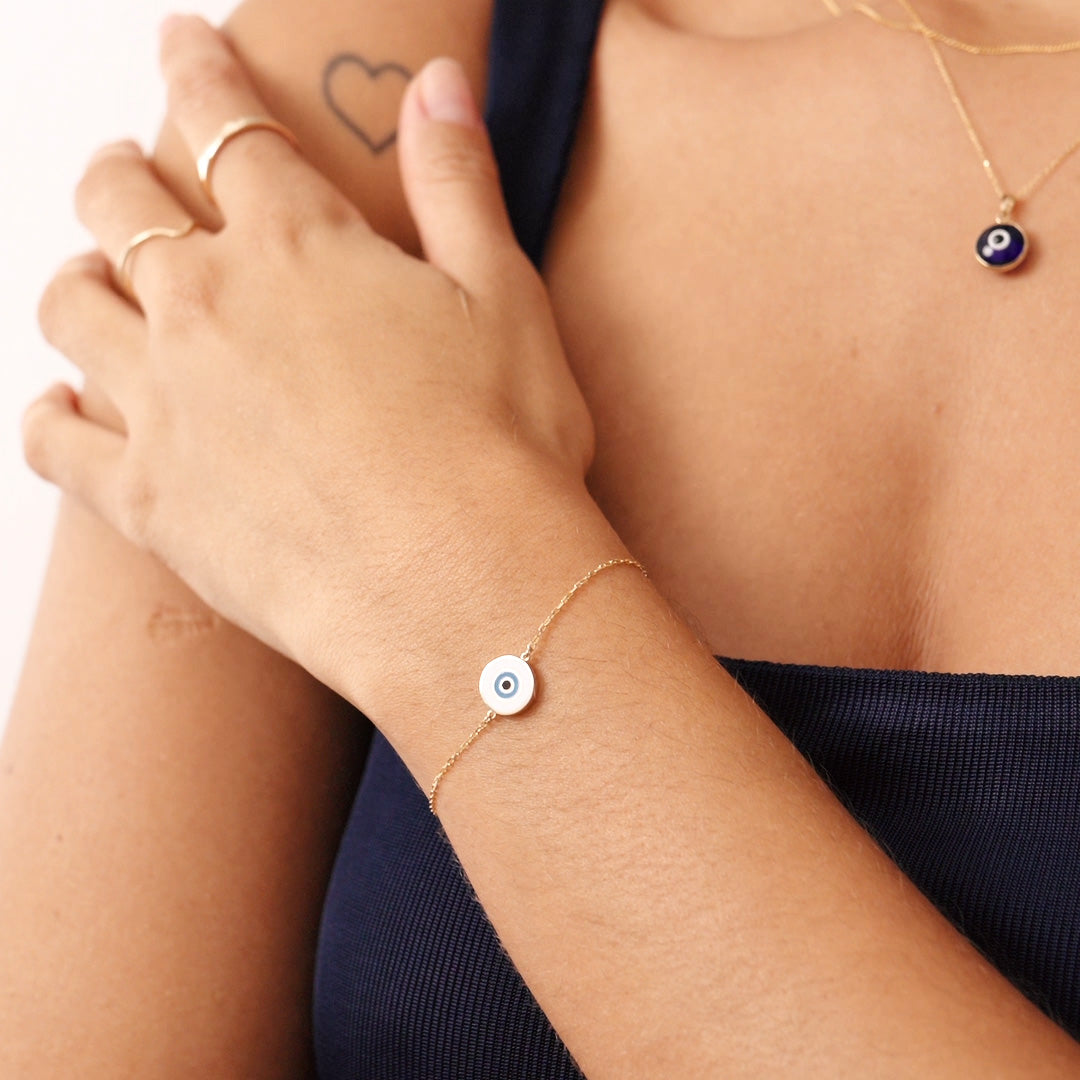 14K Real Solid Gold Evil Eye Bracelet with a white enamel charm, symbolizing protection and good fortune. Adjustable chain for a secure fit, perfect for daily wear.
