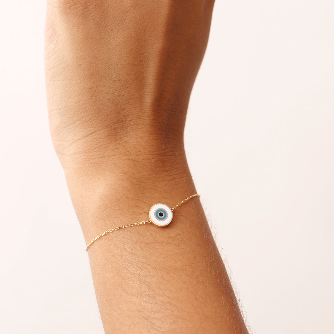 14K Real Solid Gold Evil Eye Bracelet with a white enamel charm, symbolizing protection and good fortune. Adjustable chain for a secure fit, perfect for daily wear.