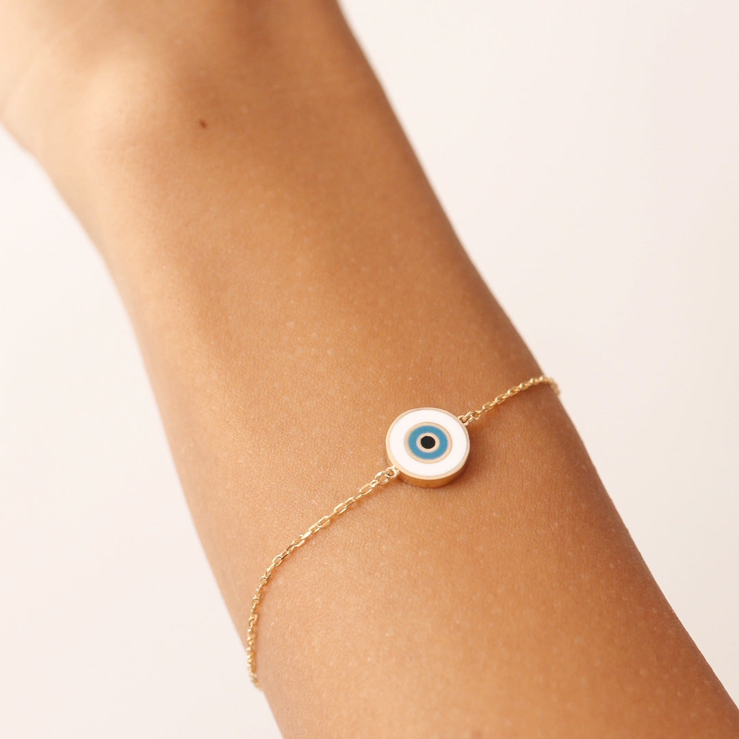 14K Real Solid Gold Evil Eye Bracelet with a white enamel charm, symbolizing protection and good fortune. Adjustable chain for a secure fit, perfect for daily wear.