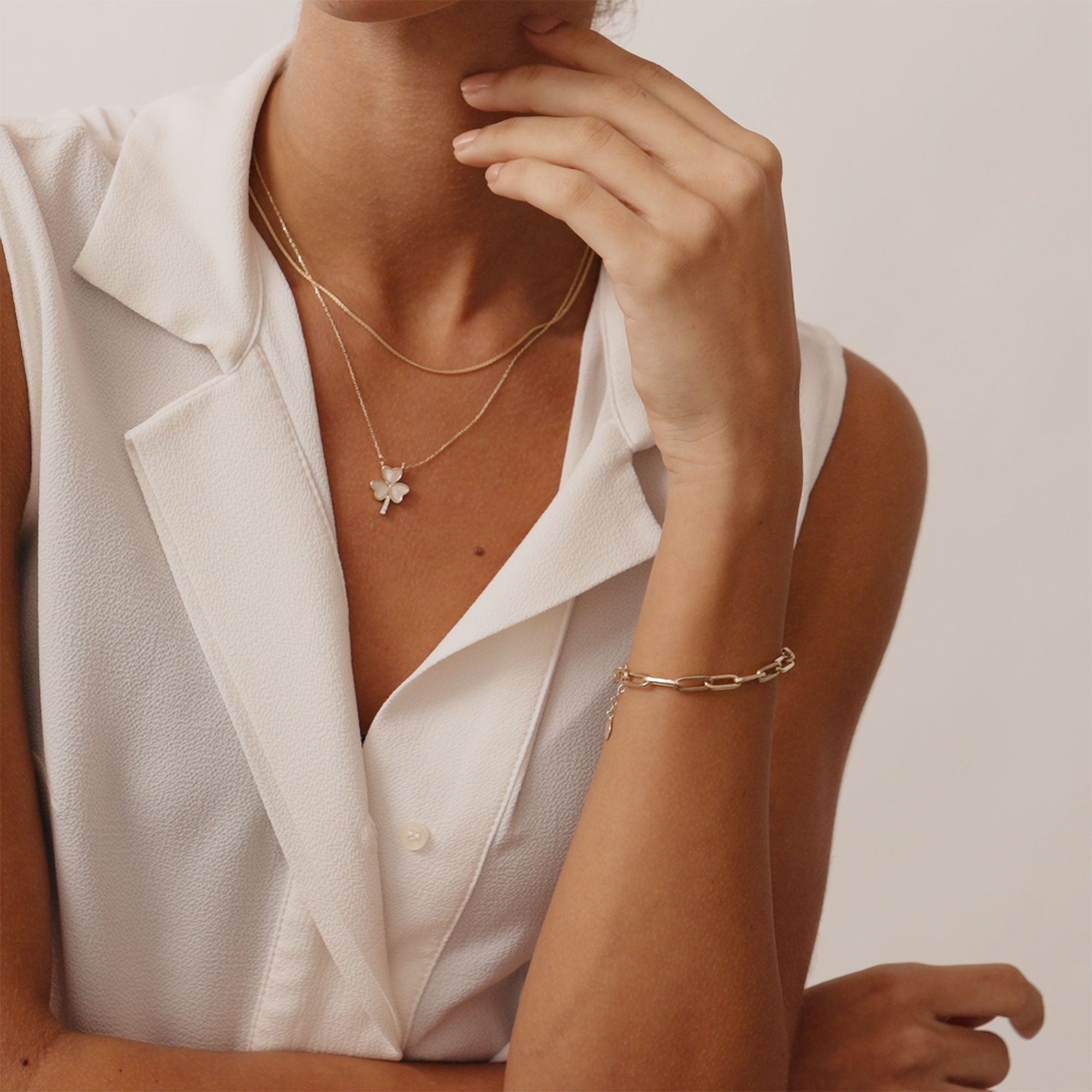 14K solid gold paperclip chain bracelet with elongated links on a wrist. A stylish and modern bracelet perfect for layering or wearing alone, suitable as a gift for her or him for special occasions.