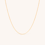 14K solid yellow gold dainty curb chain necklace with a minimalist design, featuring delicate Cuban links. Perfect for layering or wearing solo, this timeless gold chain adds elegance to any look, ideal for daily wear or special occasions.