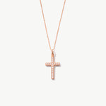 Rose gold cross necklace with diamonds on a white background
