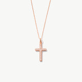 Rose gold cross necklace with diamonds on a white background