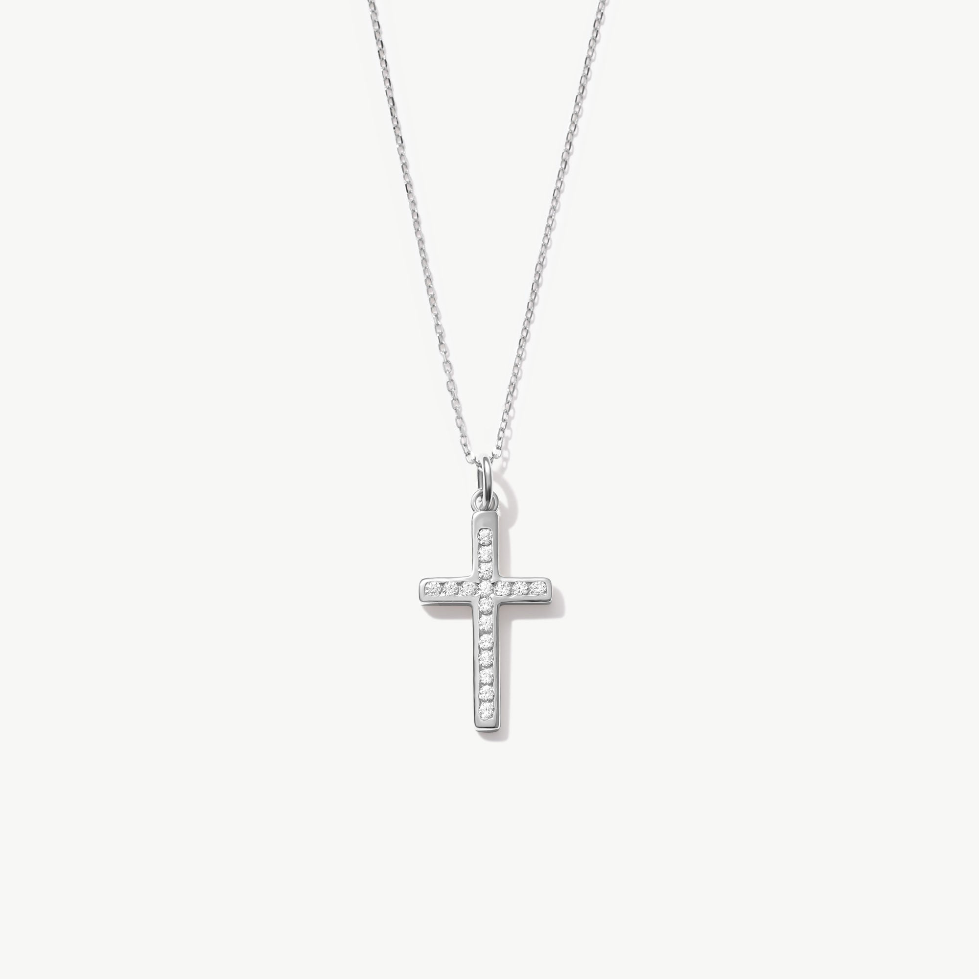 White gold cross necklace with diamonds on a white background