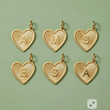 Custom initial heart charms in 14K solid gold, personalized jewelry collection.