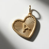 Premium 14K gold initial A heart pendant featuring 3D raised letter design and sunburst engraving.