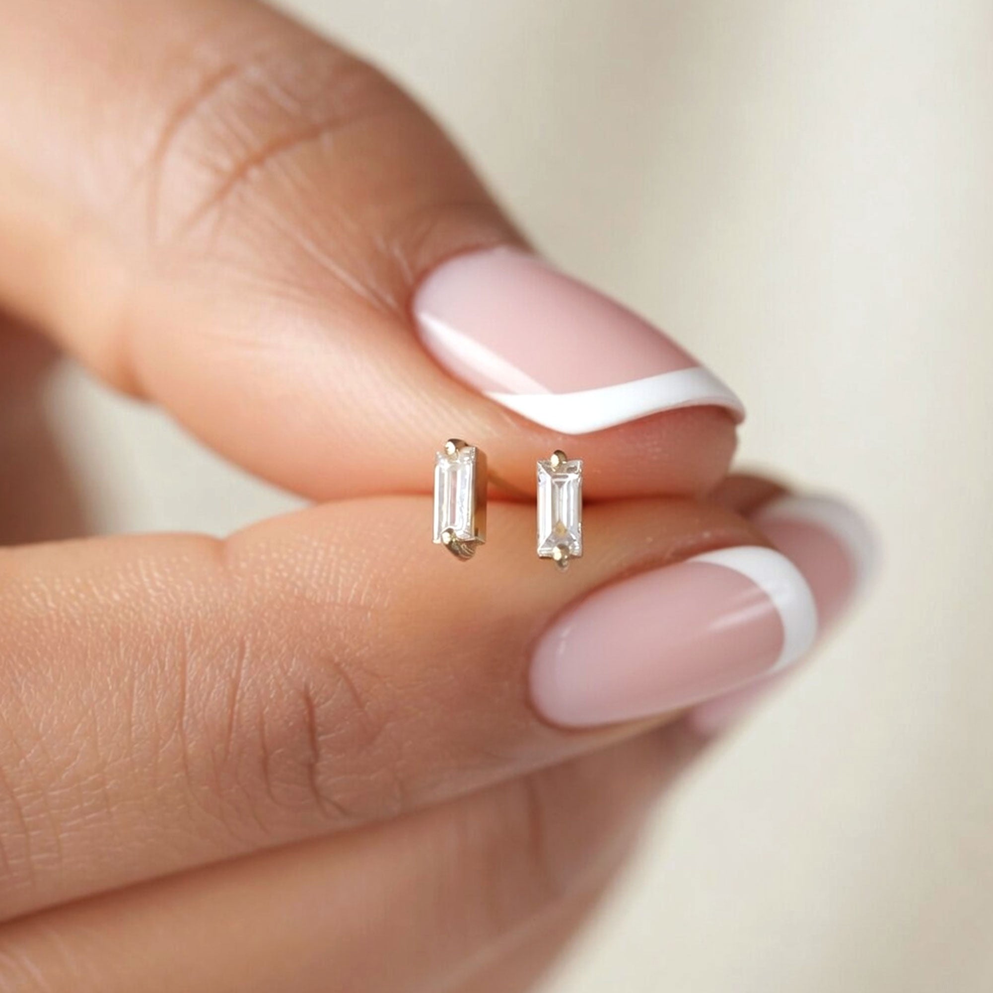Tiny Baguette Diamond Stud Earrings Held By Hand