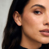 Lifestyle image featuring marquise diamond flower stud earrings worn on the ear with elegant everyday styling.