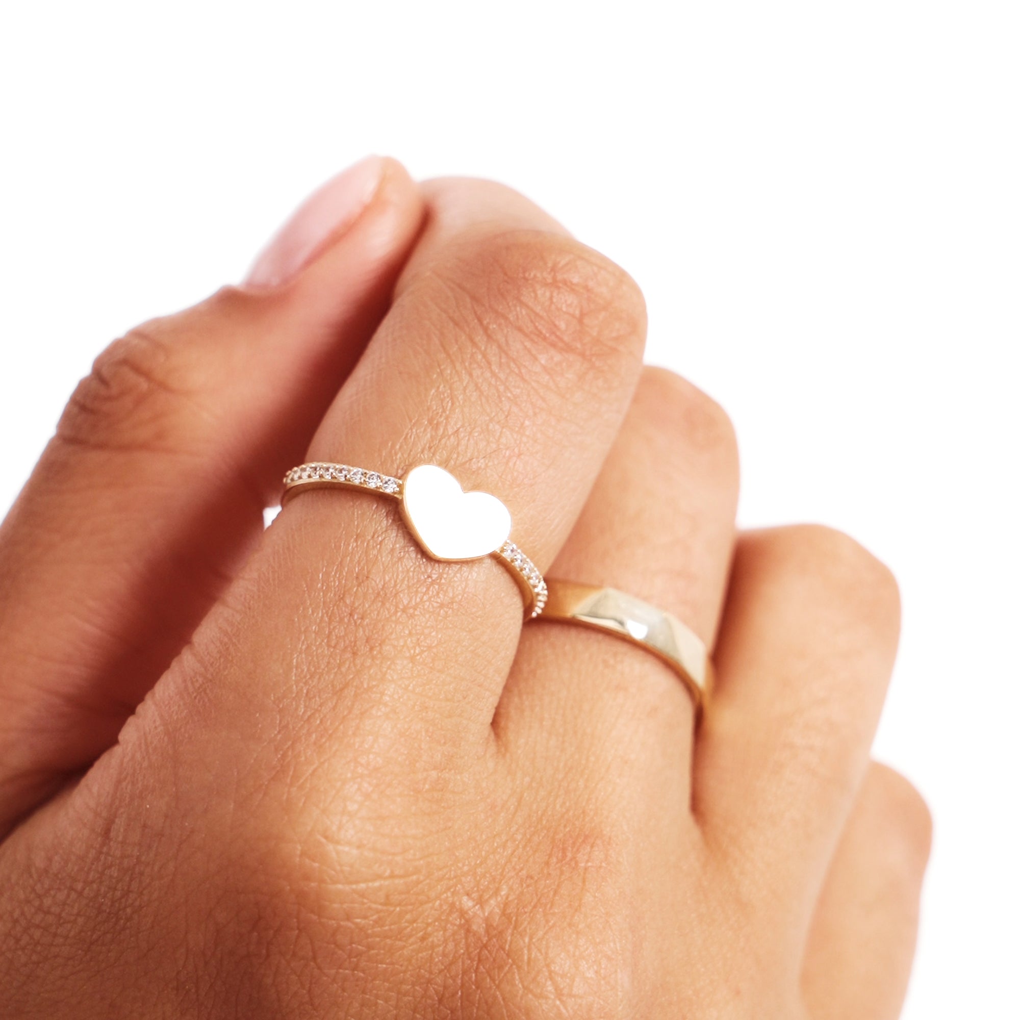 Close Up Of Woman Wearing Gold Diamond Heart Ring