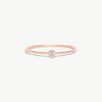 Rose gold birthstone ring featuring a natural diamond center stone in a delicate bezel setting crafted from genuine 14K solid rose gold.