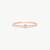 Rose gold birthstone ring featuring a natural diamond center stone in a delicate bezel setting crafted from genuine 14K solid rose gold.