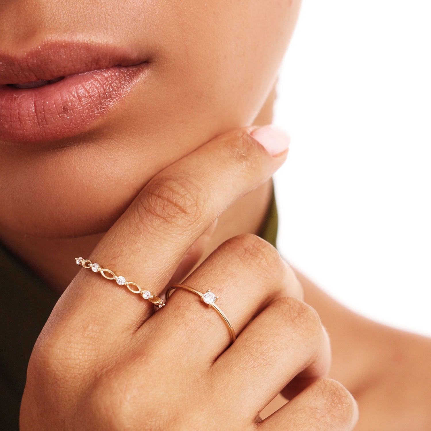 Editorial close-up of a woman wearing a dainty natural diamond solitaire ring crafted from genuine 14K solid gold with elegant minimalist styling.