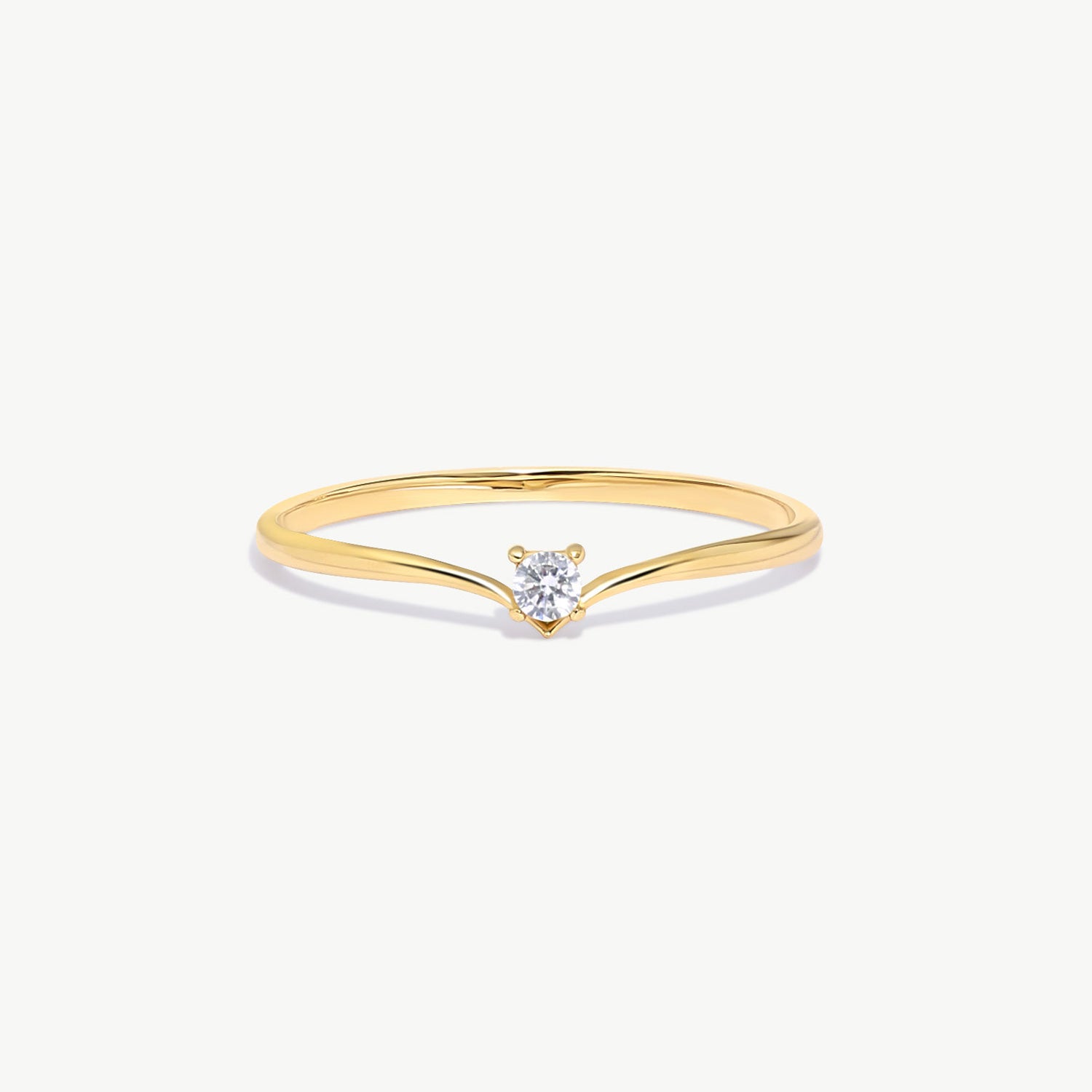 Minimalist 14K solid gold wishbone ring featuring a natural round brilliant diamond in a delicate solitaire setting on a thin V shaped polished gold band photographed on a white background.