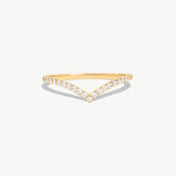 Minimalist 14K solid gold wishbone eternity ring featuring natural round brilliant diamonds pavé set along a delicate V shaped band photographed on a white background.