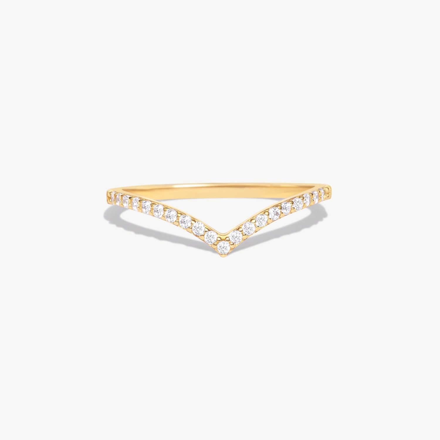 Minimalist 14K solid gold wishbone eternity ring featuring natural round brilliant diamonds pavé set along a delicate V shaped band photographed on a white background.