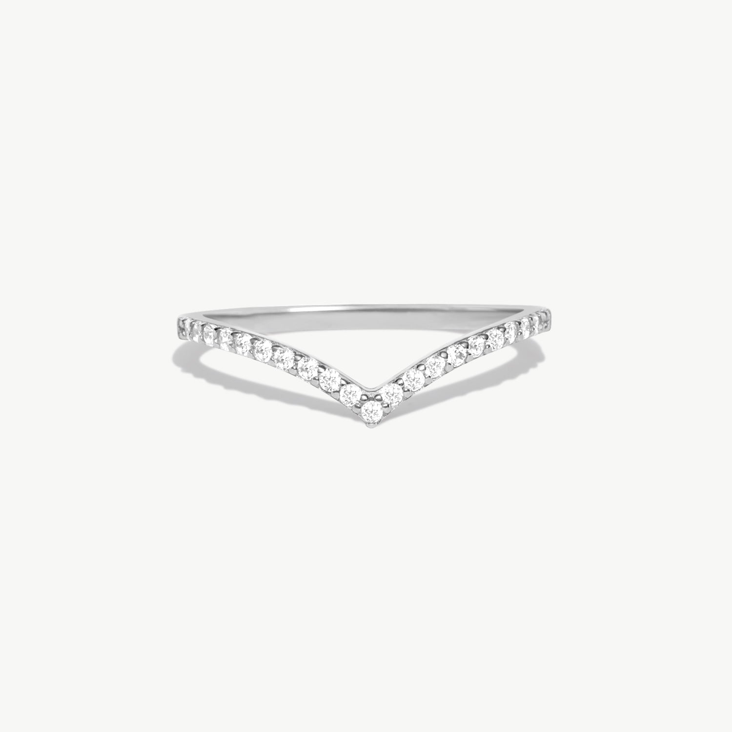 White gold wishbone eternity ring featuring pavé set natural round diamonds arranged along a refined V shaped wedding band design.